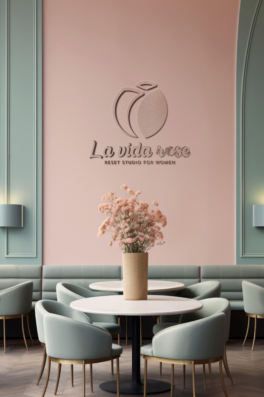 A serene mint-and-blush dining nook inside La Vida Rose with rounded chairs and a dried floral centerpiece